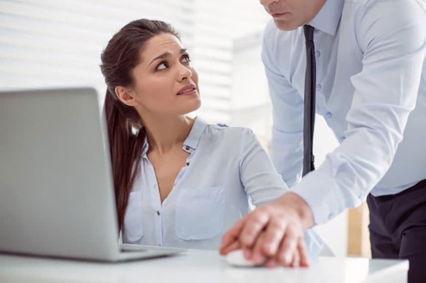 Woman sitting table looking her boss while being physically or sexually harassed