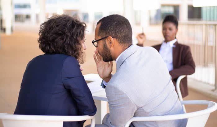 Employees gossiping about colleague