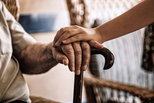 Depressed old mans hand holding for care